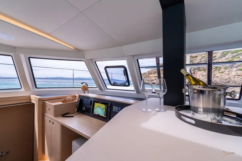 Slide: The Image of Interior of the Nautitech 44 Open with panoramic windows, a table, and a wine cooler. - 50