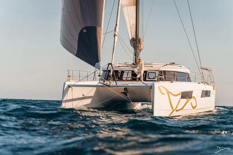 Slide: The Image of A modern catamaran sailboat sailing on the sea, featuring sleek lines and a large sail. - 25