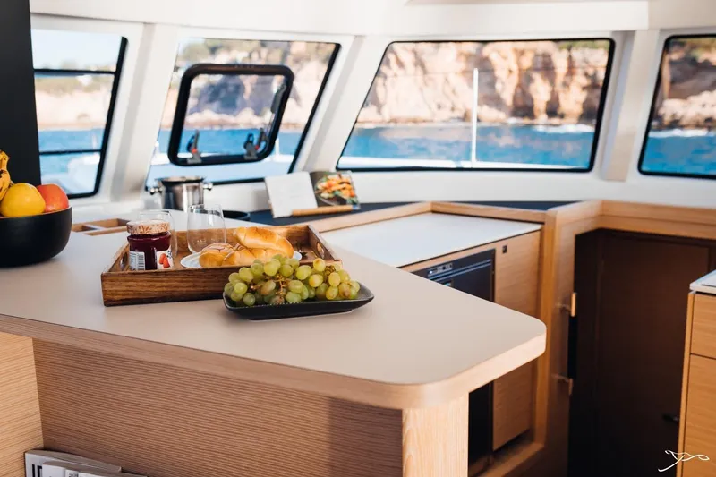 Slide: The Image of The interior of a 2027 Nautitech 44 Open features a modern kitchen with fruit and pastries. - 43