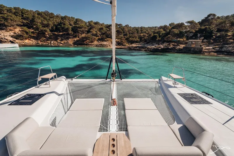 Slide: The Image of The image shows the deck of a 2027 Nautitech 44 Open, set against a scenic coastal backdrop. - 24