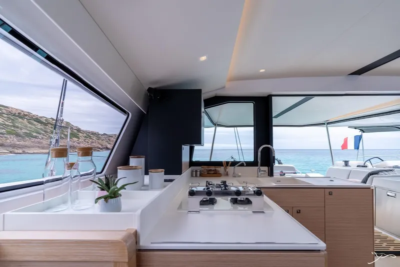 Slide: The Image of The 2027 Nautitech 44 Open features a modern kitchen with a view of the sea. - 42