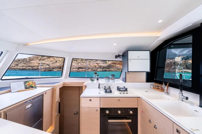 Slide: The Image of The modern kitchen on the Nautitech 44 Open features large windows overlooking the sea. - 39
