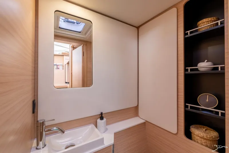Slide: The Image of Modern bathroom with sink, mirror, and storage in a 2027 Nautitech 44 Open. - 45