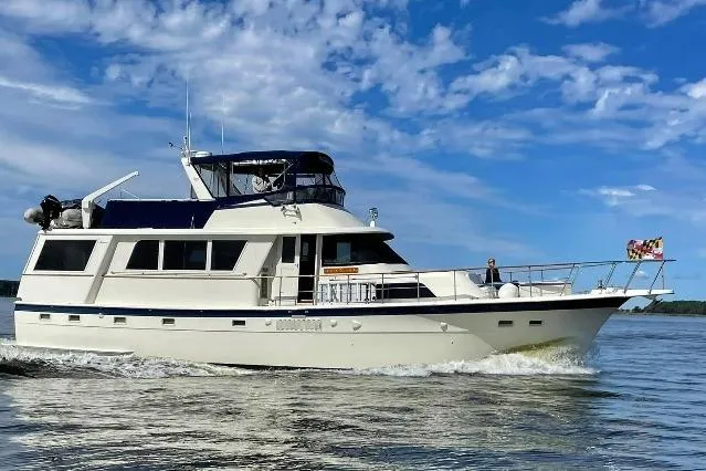 The Image of 1978 Hatteras 58 Motor Yacht cruising on a sunny day with blue skies. - 0