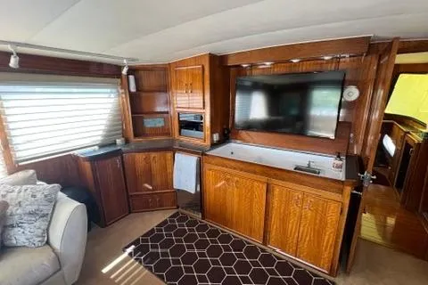 Slide: The Image of Interior of a 1978 Hatteras 58 Motor Yacht with wood cabinetry and a mounted TV. - 8