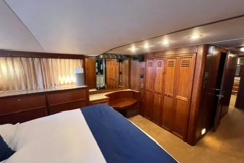 Slide: The Image of 1978 Hatteras 58 Motor Yacht interior with wood paneling and cozy bedroom. - 21