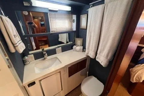 Slide: The Image of 1978 Hatteras 58 Motor Yacht bathroom with sink, mirror, and towels. - 24