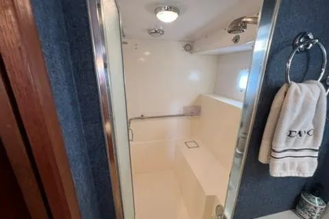 Slide: The Image of 1978 Hatteras 58 Motor Yacht bathroom with shower, towel rack, and modern fixtures. - 25