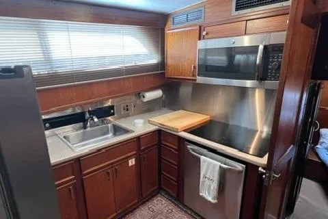 Slide: The Image of 1978 Hatteras 58 Motor Yacht kitchen with wood cabinets and stainless steel appliances. - 12