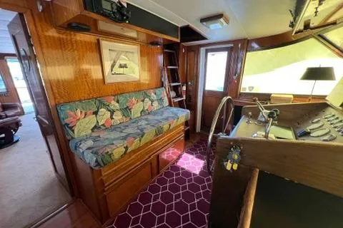 Slide: The Image of Interior of a 1978 Hatteras 58 Motor Yacht with floral seating and wooden accents. - 37