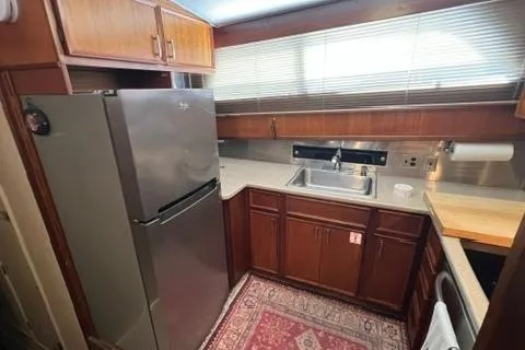 Slide: The Image of 1978 Hatteras 58 Motor Yacht kitchen with wooden cabinets and stainless steel appliances. - 13