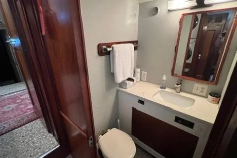 Slide: The Image of 1978 Hatteras 58 Motor Yacht bathroom with sink, mirror, and wooden accents. - 16