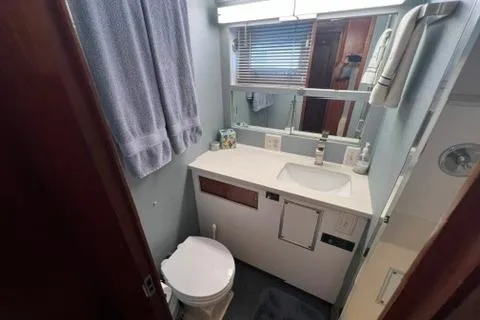 Slide: The Image of Bathroom interior of 1978 Hatteras 58 Motor Yacht with sink, mirror, and toilet. - 18