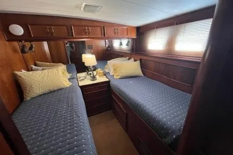 Slide: The Image of 1978 Hatteras 58 Motor Yacht cabin with twin beds and wooden interior. - 17
