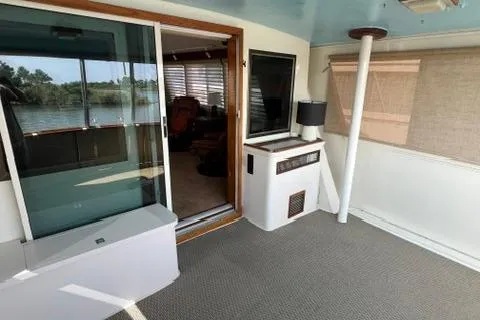 Slide: The Image of 1978 Hatteras 58 Motor Yacht interior with carpeted deck and sliding glass door. - 10
