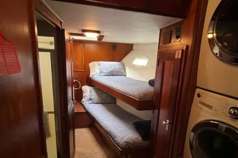 Slide: The Image of Interior of 1978 Hatteras 58 Motor Yacht with bunk beds and laundry area. - 14
