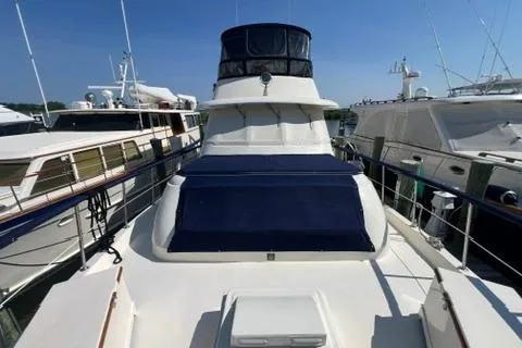 Slide: The Image of 1978 Hatteras 58 Motor Yacht docked among other luxury boats. - 28