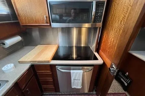 Slide: The Image of 1978 Hatteras 58 Motor Yacht kitchen with modern appliances and wooden cabinetry. - 26