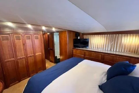 Slide: The Image of 1978 Hatteras 58 Motor Yacht bedroom with wood paneling, bed, and TV. - 22