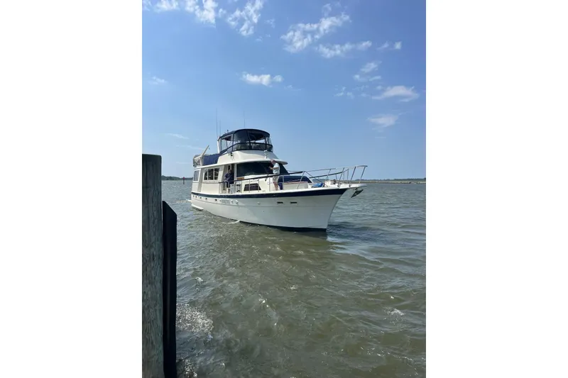 Slide: The Image of 1978 Hatteras 58 Motor Yacht cruising on a sunny day with clear skies. - 5