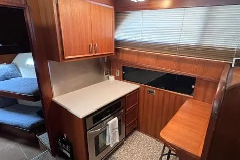 Slide: The Image of 1978 Hatteras 58 Motor Yacht kitchen with wood cabinetry and modern appliances. - 11