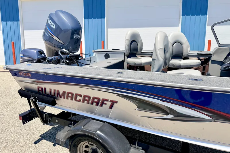 Slide: The Image of 2005 Alumacraft Tournament Sport 175 boat with Yamaha 150 engine, parked outdoors. - 11