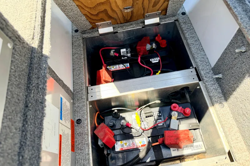 Slide: The Image of 2005 Alumacraft Tournament Sport 175 boat battery compartment with wiring and connections. - 59