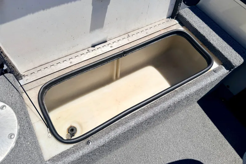Slide: The Image of Open storage compartment on a 2005 Alumacraft Tournament Sport 175 boat. - 29
