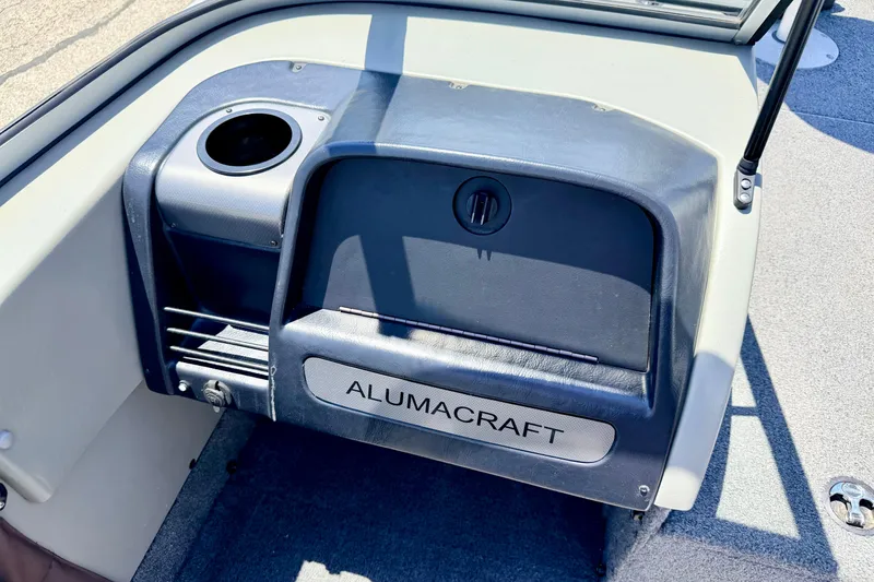 Slide: The Image of 2005 Alumacraft Tournament Sport 175 boat dashboard with storage compartment and cup holder. - 38