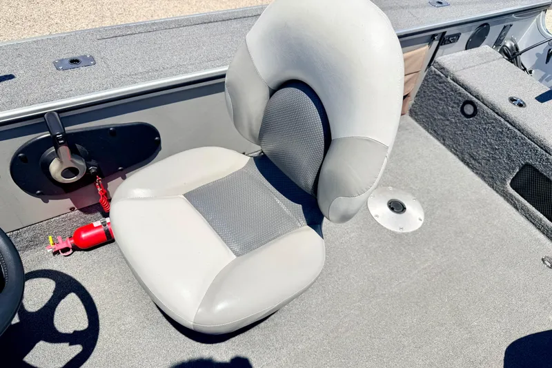 Slide: The Image of 2005 Alumacraft Tournament Sport 175 boat interior with gray seating and fire extinguisher. - 44