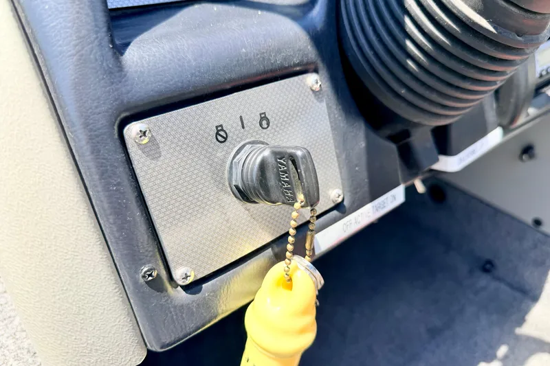 Slide: The Image of Close-up of a 2005 Alumacraft Tournament Sport 175 ignition switch with Yamaha key. - 50