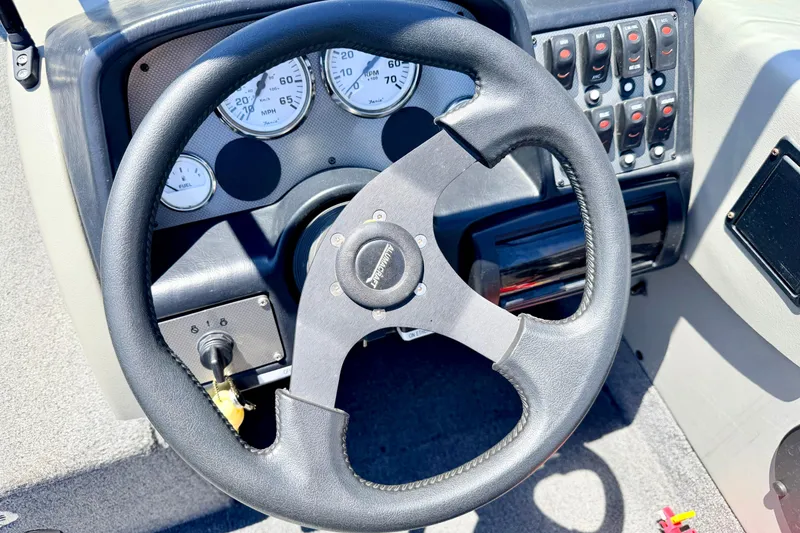 Slide: The Image of 2005 Alumacraft Tournament Sport 175 dashboard with steering wheel and instrument panel. - 45