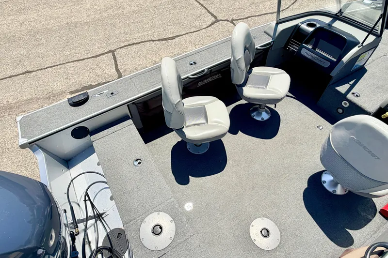 Slide: The Image of 2005 Alumacraft Tournament Sport 175 boat interior with swivel seats and carpeted deck. - 78