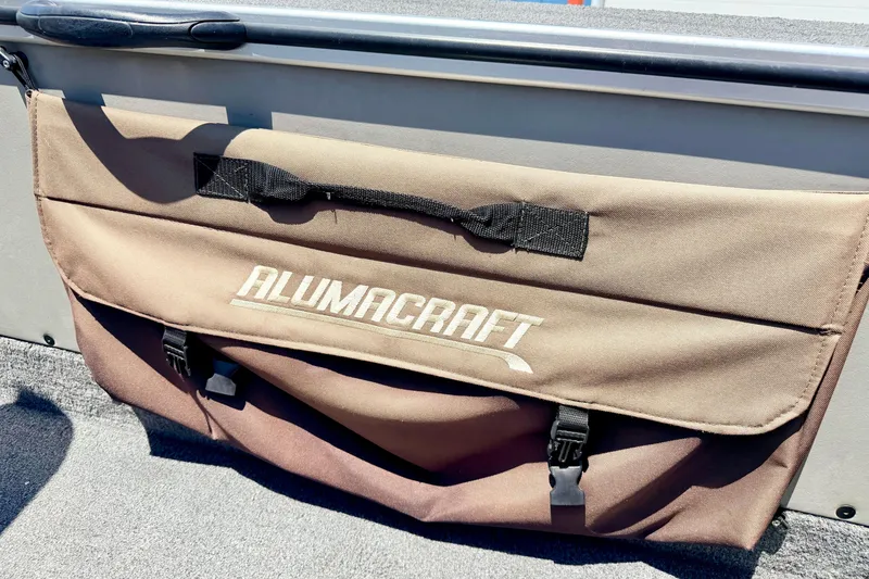 Slide: The Image of Brown storage bag on 2005 Alumacraft Tournament Sport 175 boat, featuring logo and secure straps. - 33
