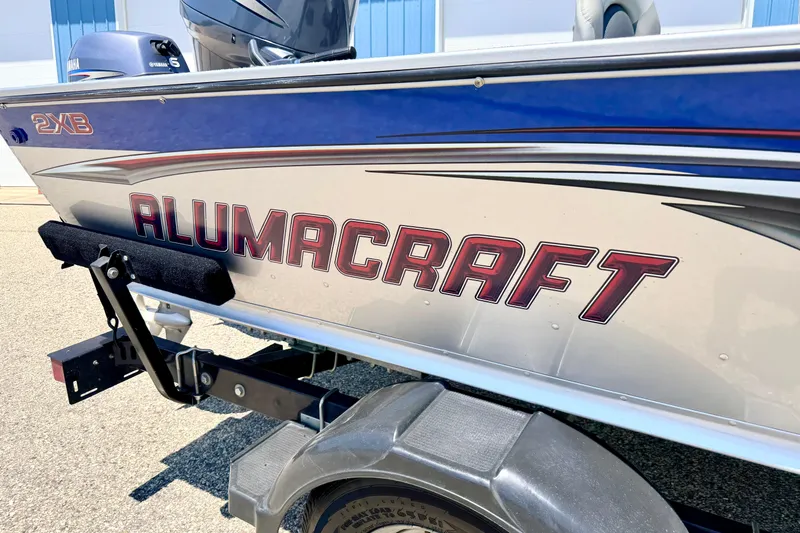 Slide: The Image of 2005 Alumacraft Tournament Sport 175 boat on trailer, featuring bold branding. - 10