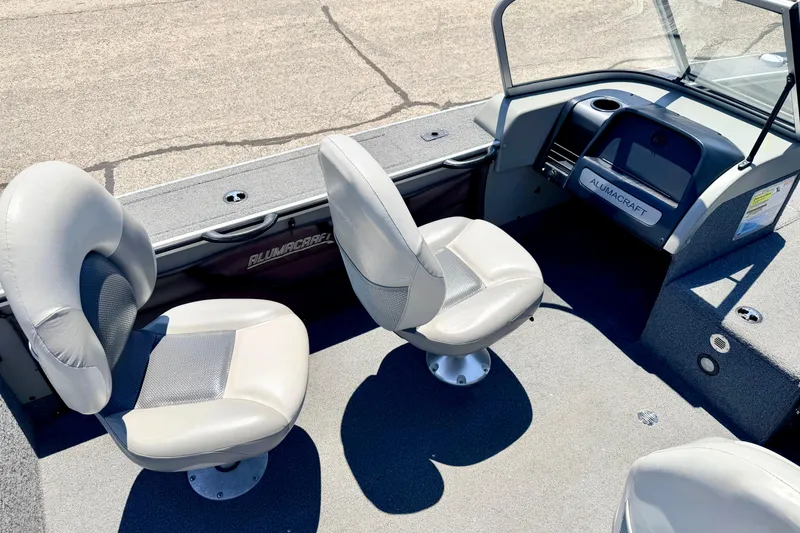 Slide: The Image of 2005 Alumacraft Tournament Sport 175 boat interior with two swivel seats and dashboard. - 35