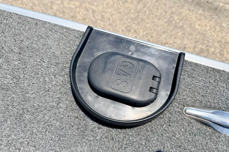 Slide: The Image of Gas cap on 2005 Alumacraft Tournament Sport 175 boat, featuring textured surface. - 30