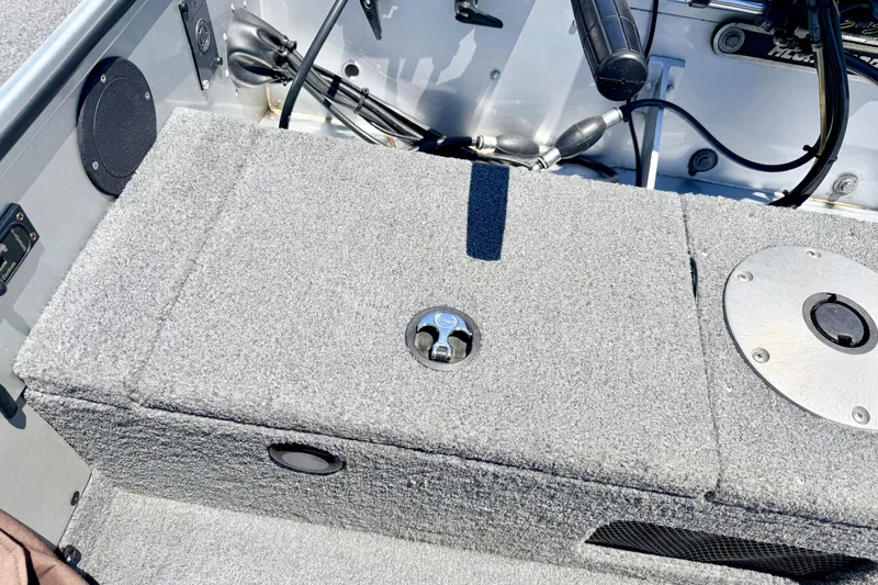 Slide: The Image of 2005 Alumacraft Tournament Sport 175 boat interior with carpeted storage compartment. - 26