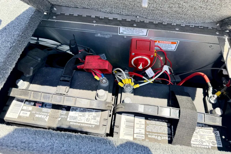 Slide: The Image of 2005 Alumacraft Tournament Sport 175 boat battery compartment with wiring and switch. - 27