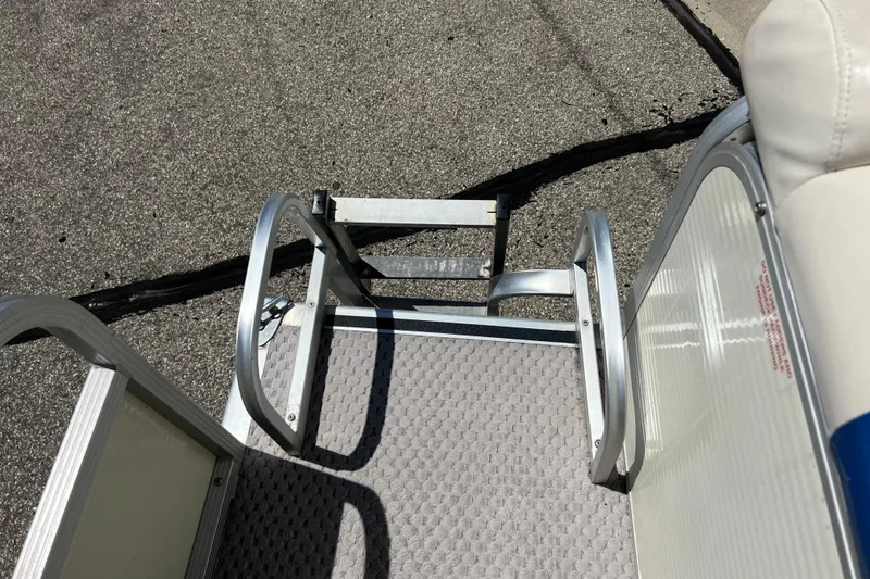 Slide: The Image of Boat ladder on a 2004 Bennington 2875RLX, resting on textured flooring. - 17