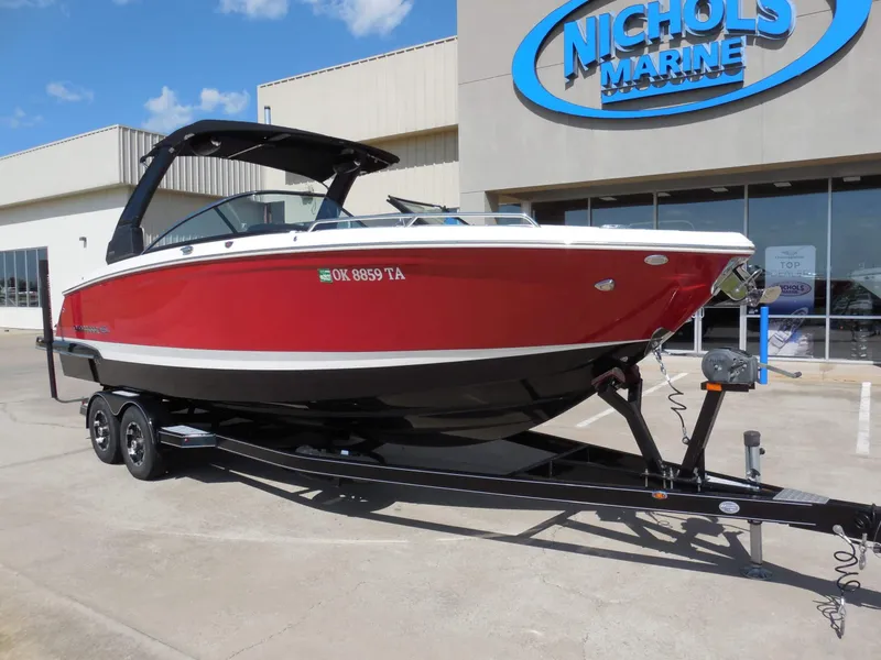 Slide: The Image of A red 2020 Chaparral 277 SSX boat on a trailer in front of a building. - 2