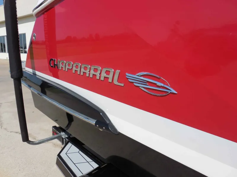Slide: The Image of Red Chaparral 277 SSX boat with shiny logo and white stripe on the stern. - 11