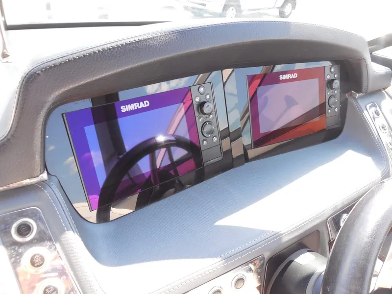 Slide: The Image of The image shows the dashboard of a 2020 Chaparral 277 SSX with two Simrad screens. - 25