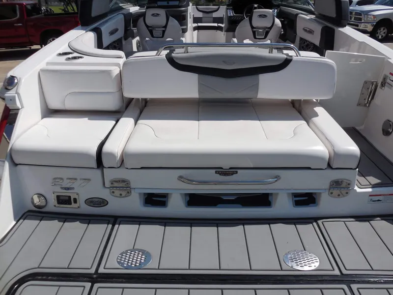 Slide: The Image of The image shows the stern of a 2020 Chaparral 277 SSX boat with white upholstery and gray decking. - 12