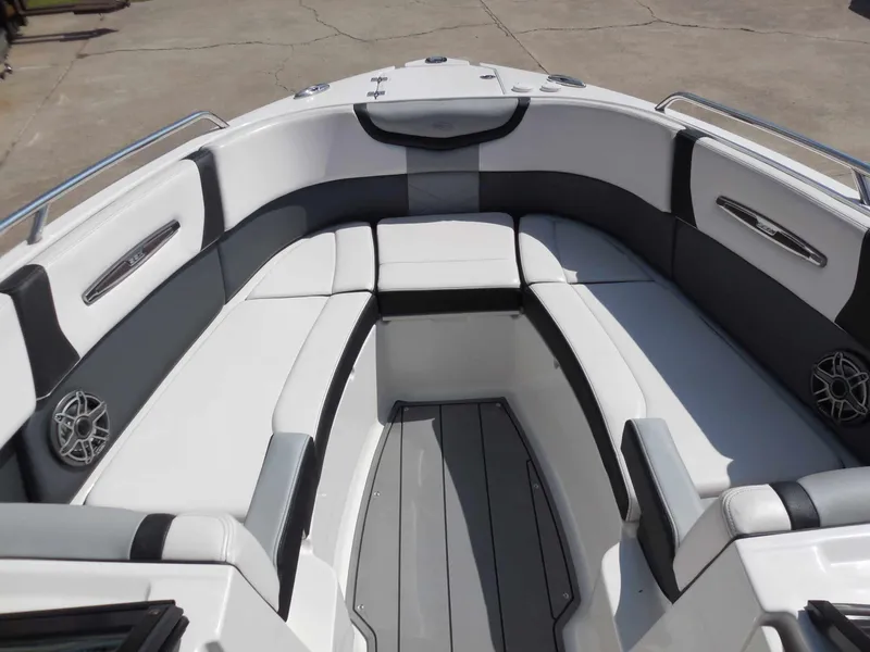 Slide: The Image of The image shows the bow area of a 2020 Chaparral 277 SSX boat with white and gray upholstery. - 20