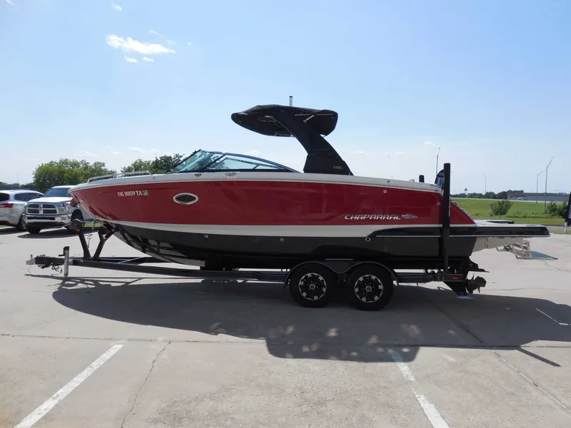 Slide: The Image of A red 2020 Chaparral 277 SSX boat on a trailer in a parking lot. - 7