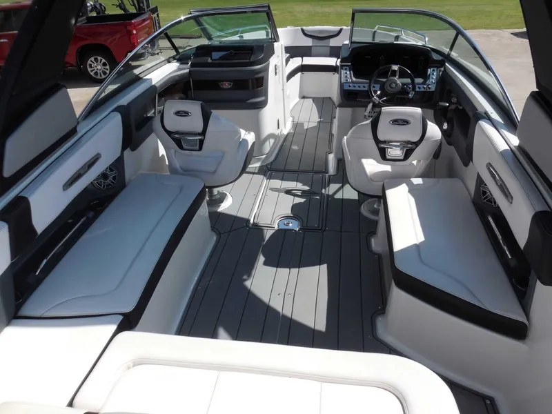Slide: The Image of The image shows the interior of a 2020 Chaparral 277 SSX boat with sleek white seating. - 14