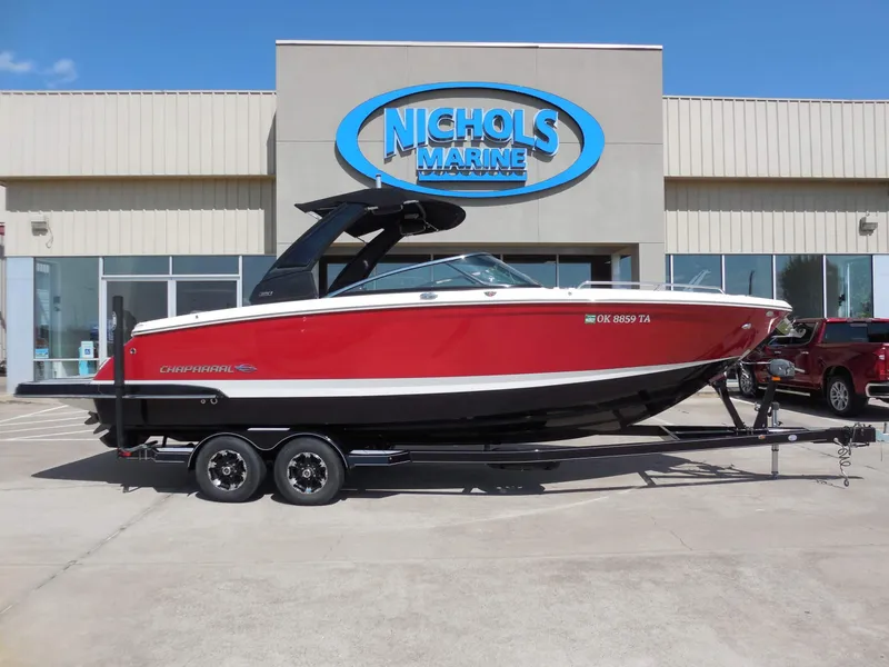 Slide: The Image of A red 2020 Chaparral 277 SSX boat on a trailer in front of a building. - 27