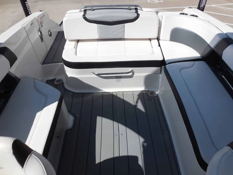 Slide: The Image of The image shows the interior of a 2020 Chaparral 277 SSX boat with white and gray seating. - 18
