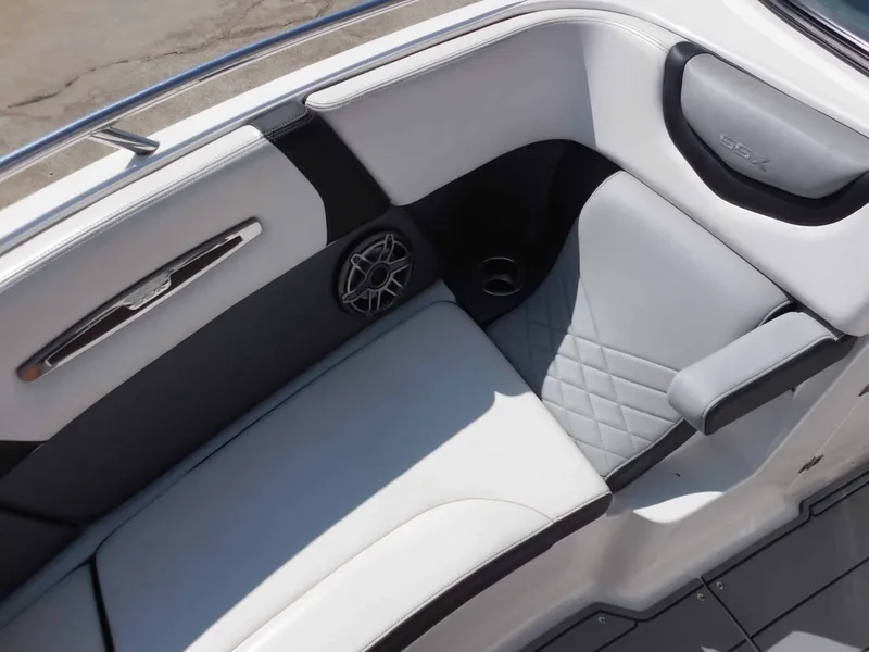 Slide: The Image of The interior of the 2020 Chaparral 277 SSX features elegant, cushioned seating with a speaker. - 22